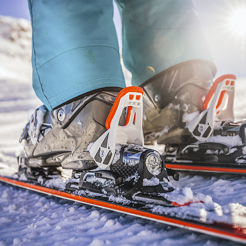 Winter skis and detailed view of the ski boots on sunny day.