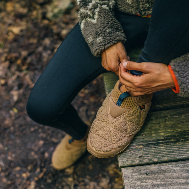 person sitting on deck, close up on shoes