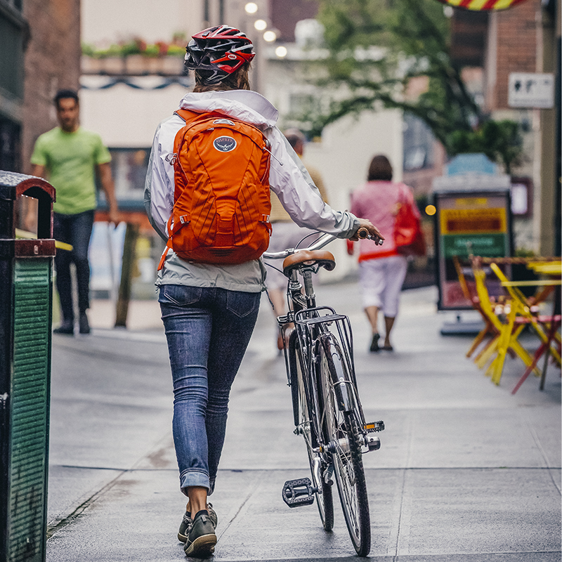 A woman walking her bike through Post Alley in Seattle, WA