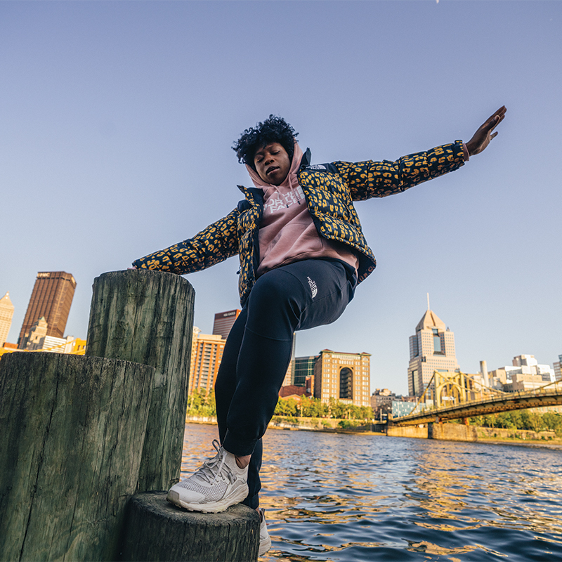 Female hanging out in downtown Pittsburgh wearing a puffer The North Face jacket